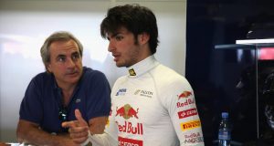NORTHAMPTON, ENGLAND - JULY 18: Carlos Sainz Jr of Spain talks with his father Carlos Sainz as he prepares to drive for the Scuderia Toro Rosso team during the young drivers test at Silverstone Circuit on July 18, 2013 in Northampton, England. (Photo by Mark Thompson/Getty Images)