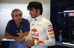 NORTHAMPTON, ENGLAND - JULY 18: Carlos Sainz Jr of Spain talks with his father Carlos Sainz as he prepares to drive for the Scuderia Toro Rosso team during the young drivers test at Silverstone Circuit on July 18, 2013 in Northampton, England. (Photo by Mark Thompson/Getty Images)