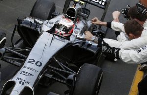Kevin Magnussen returns to the pits after a podium finish to the cheers of the team.
